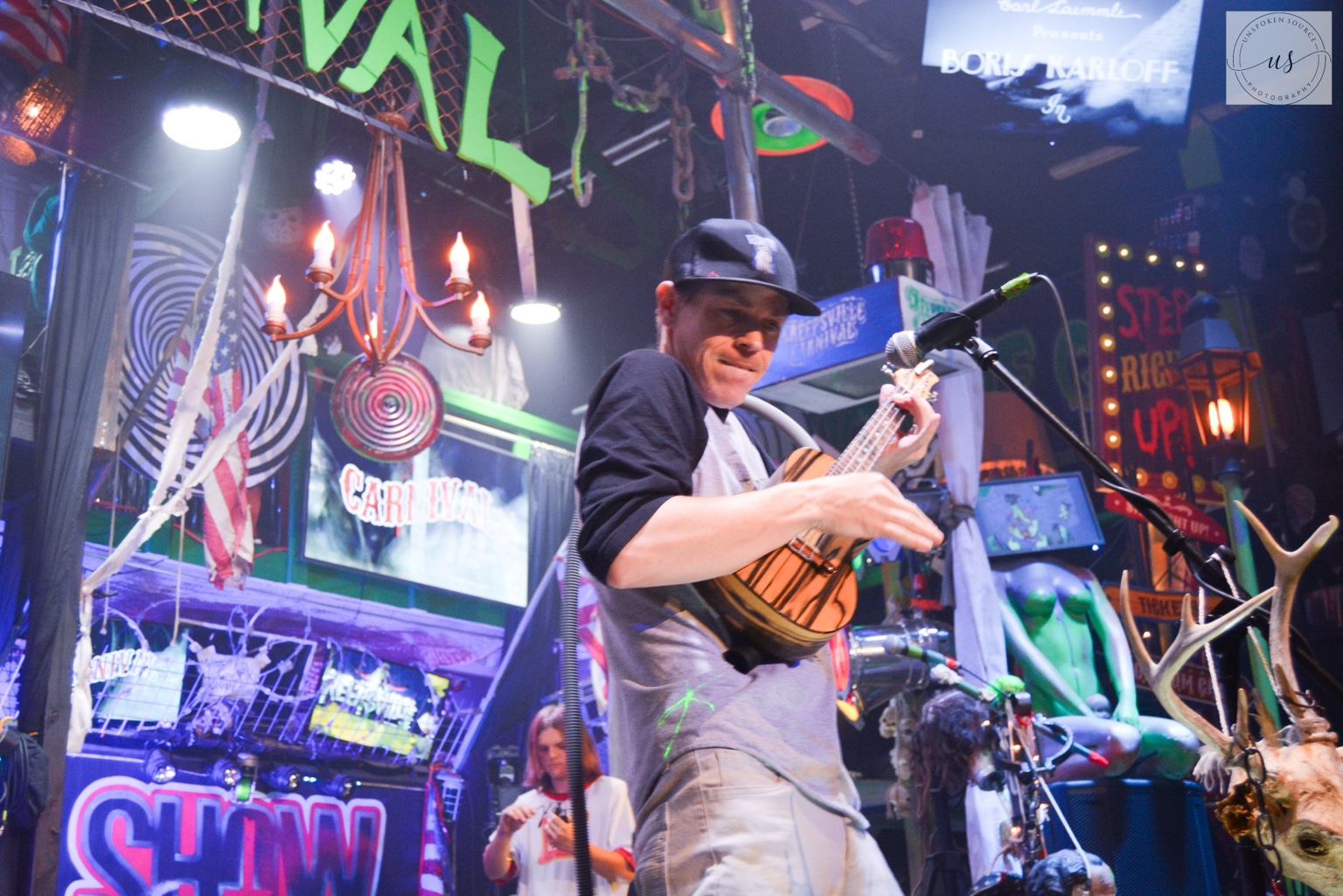 IMP performing live in a colorful carnival environment