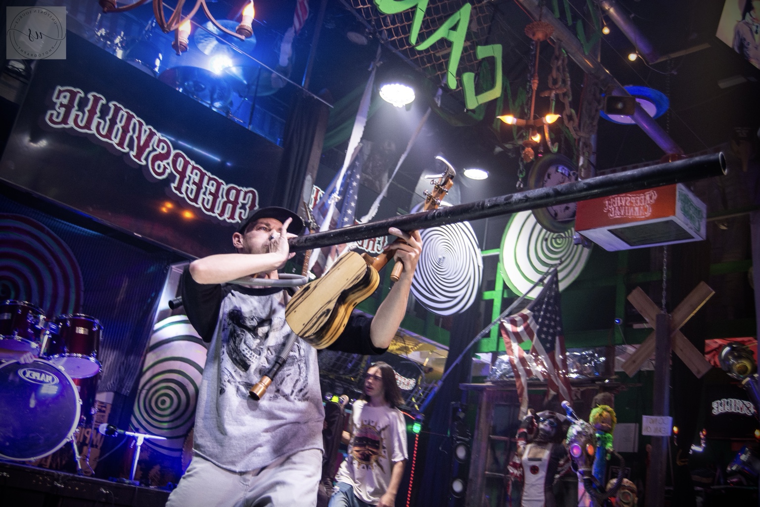 IMP performing a long horn on a carnival stage